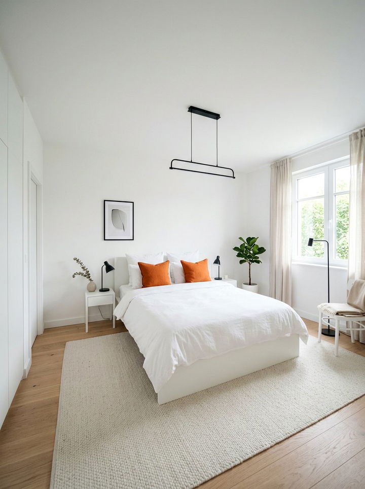 Minimalist white bedroom with orange pillows - 30 orange and white bedroom ideas