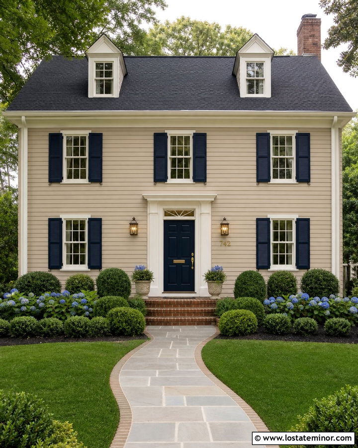 Beige House With Navy Door And Aged Brass Lanterns - 30 Beige House Design With Light Fixtures Ideas