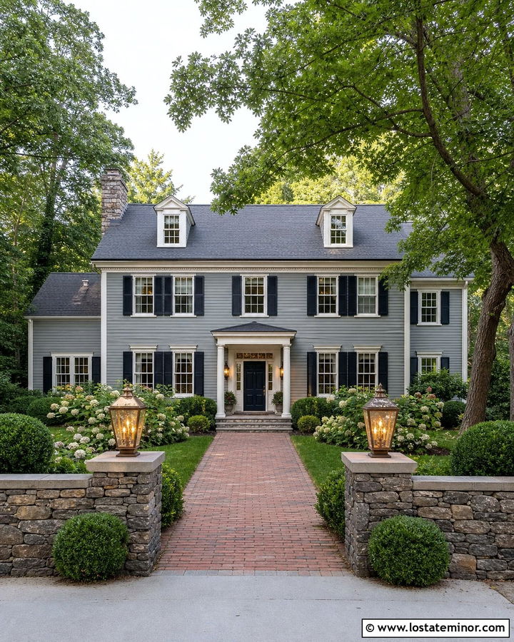 Ledgestone Colonial With Brass Lanterns - 30 Stone House Design With Light Fixtures Ideas
