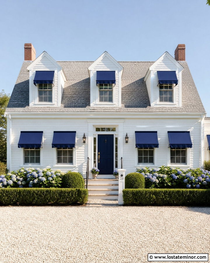 White Cape Cod House With Navy Window Awnings - 30 White House Design With Awning Ideas