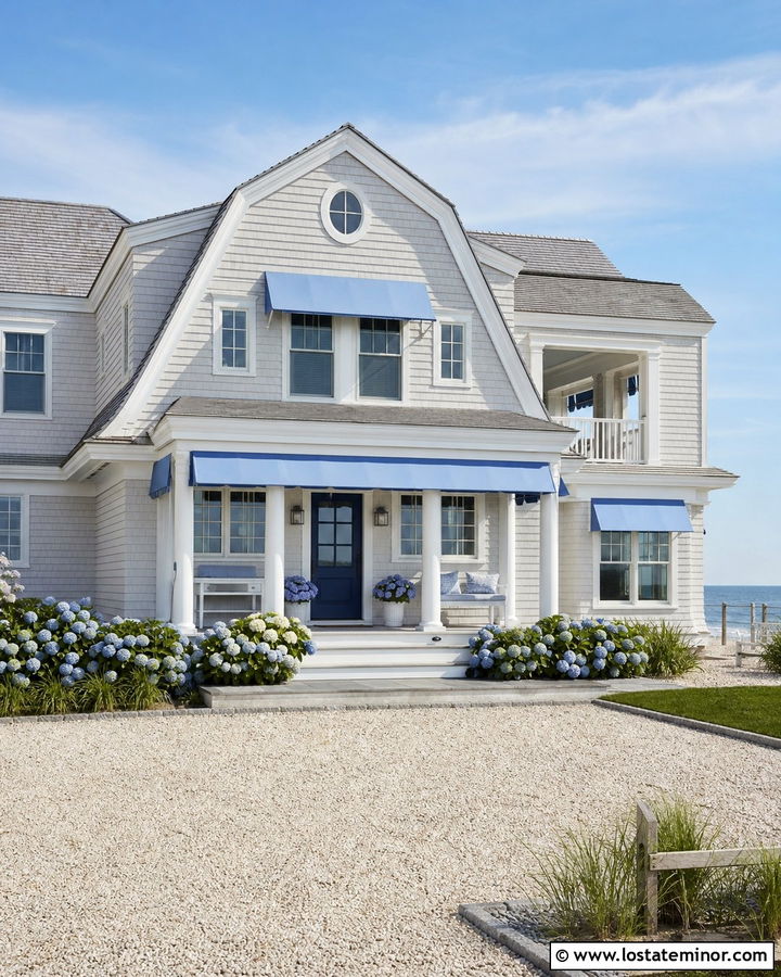 White Coastal House With Blue Fabric Awning - 30 White House Design With Awning Ideas