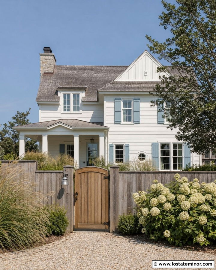 White Coastal House With Weathered Gray Fence - 30 White House Design With Fence Ideas