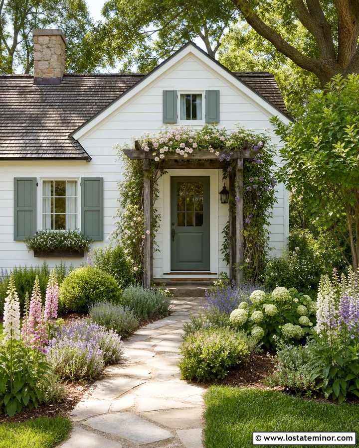 White Cottage With Flowering Pergola - 30 White House Design With Pergola Ideas